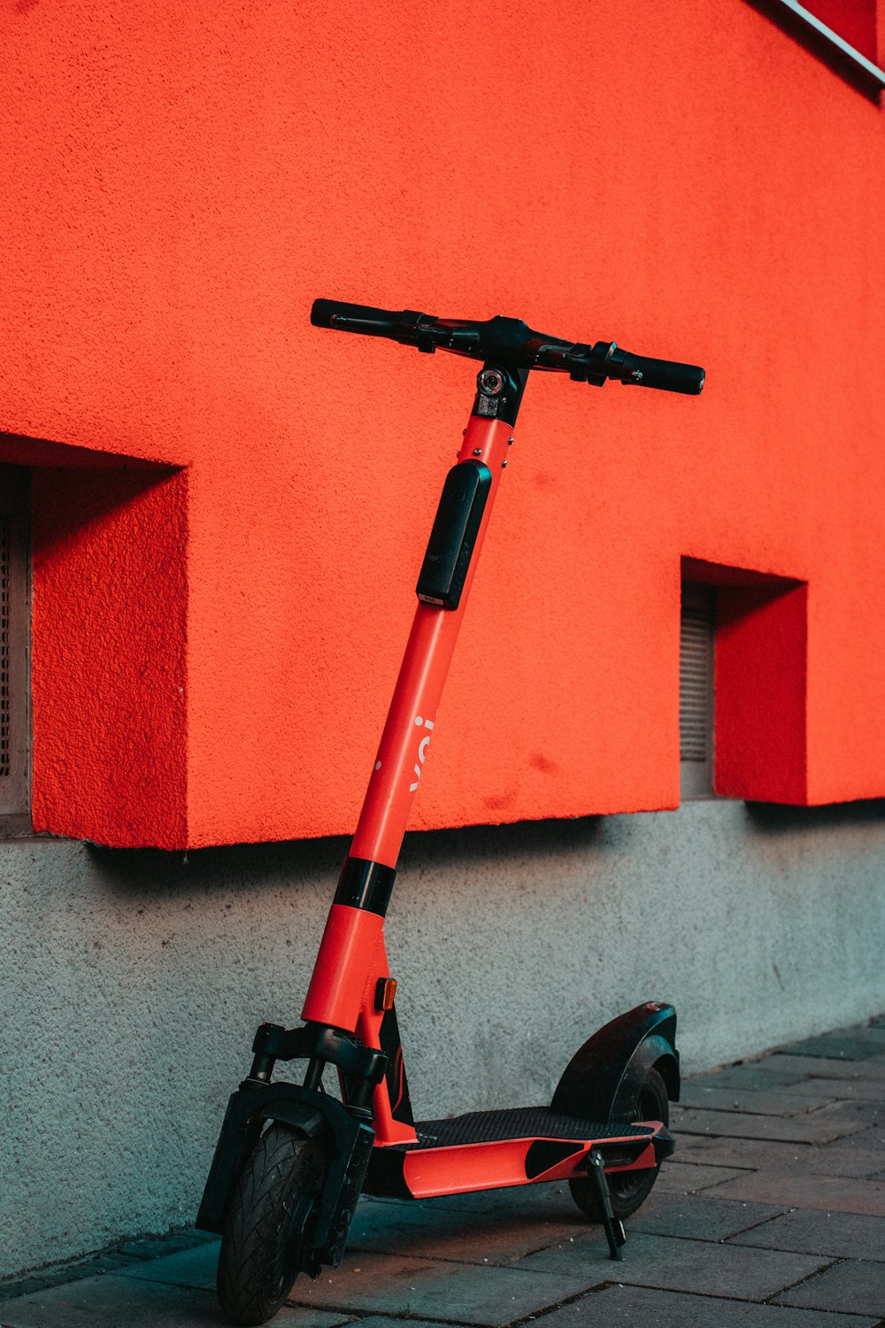 black and red bicycle near red wall