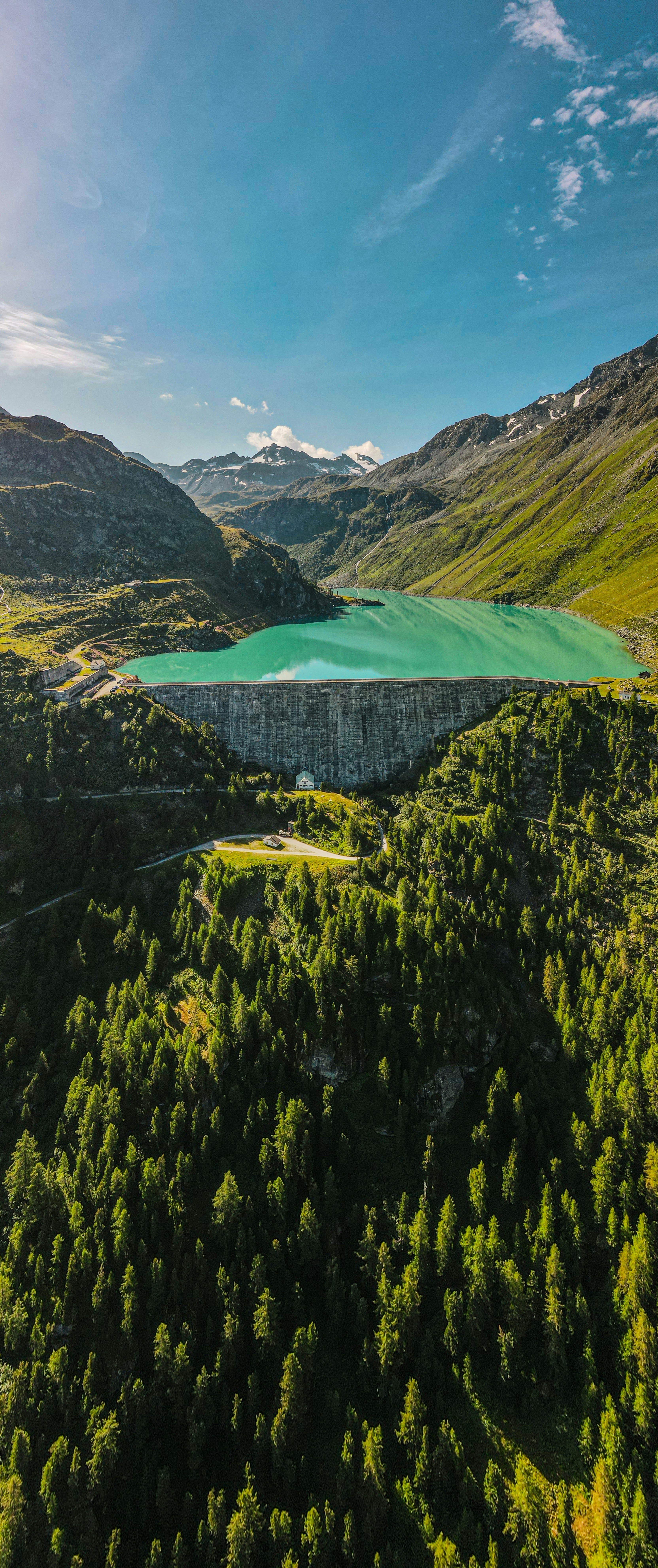 an aerial view of a lake surrounded by mountains