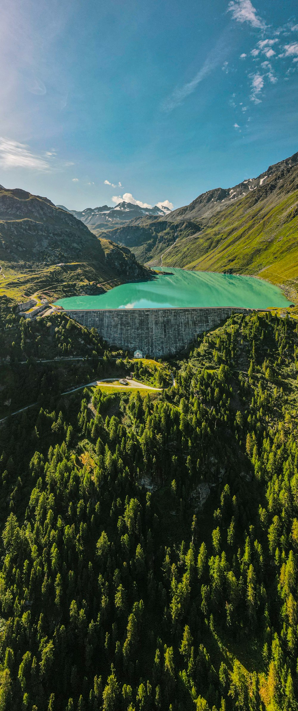 an aerial view of a lake surrounded by mountains