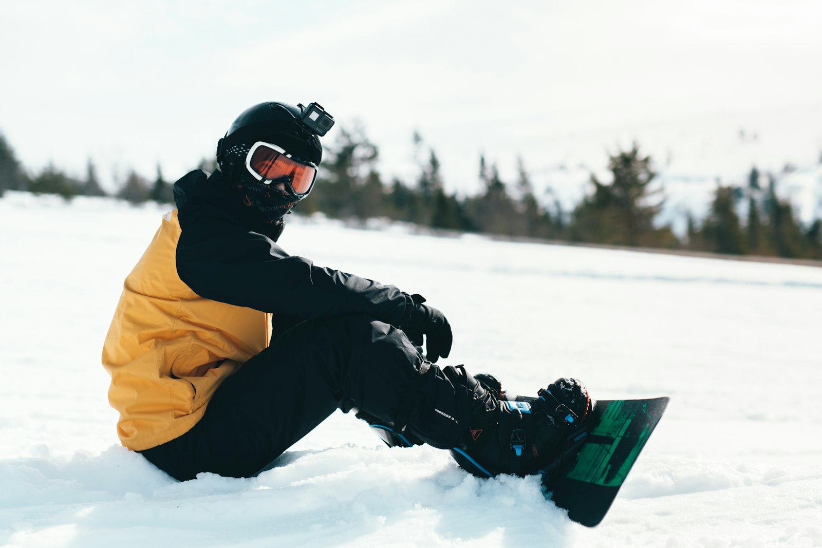 Rider with boots strapped into the bindings of a snowboard