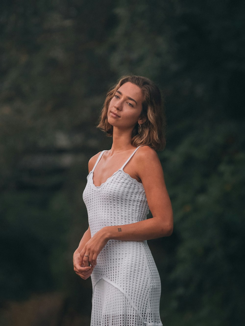 woman in white tank top standing