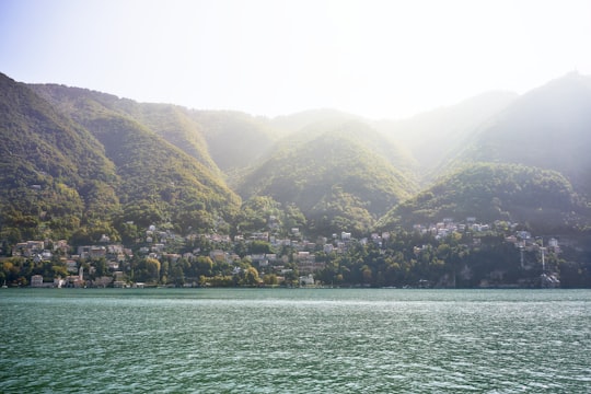 green and brown mountains beside body of water during daytime in Como Italy