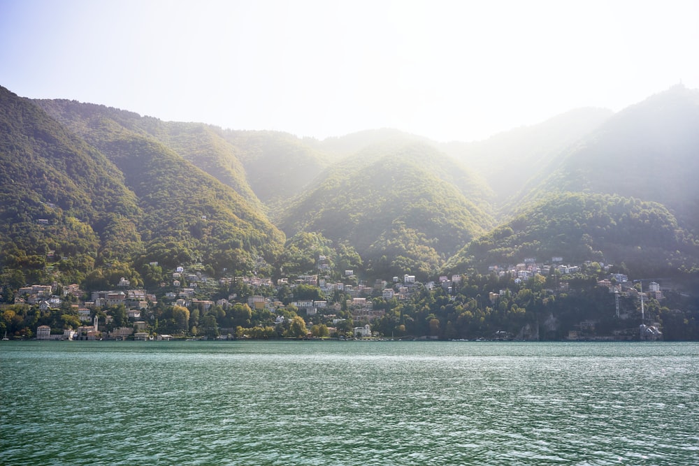 green and brown mountains beside body of water during daytime