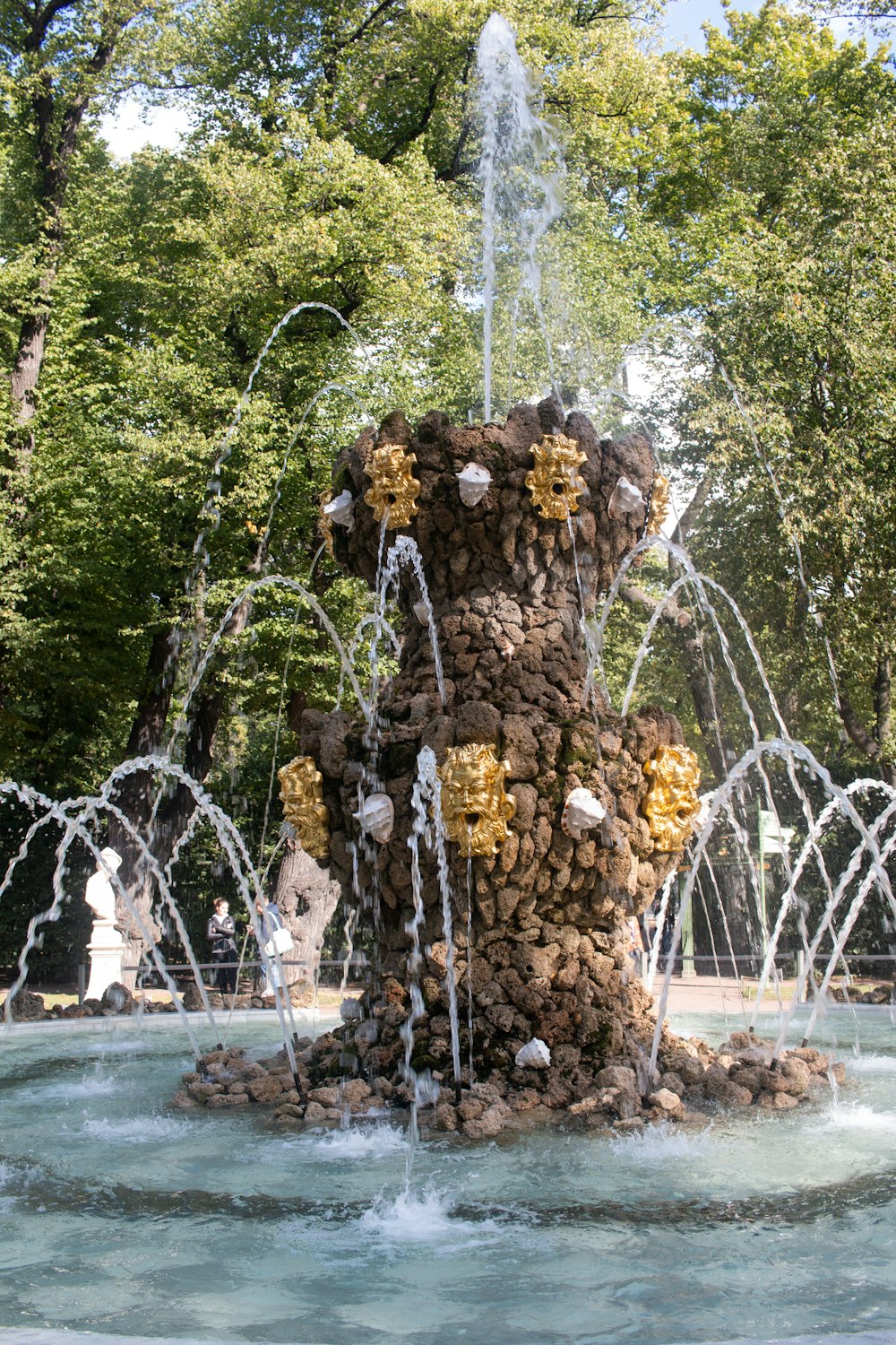 water fountain in the middle of the forest