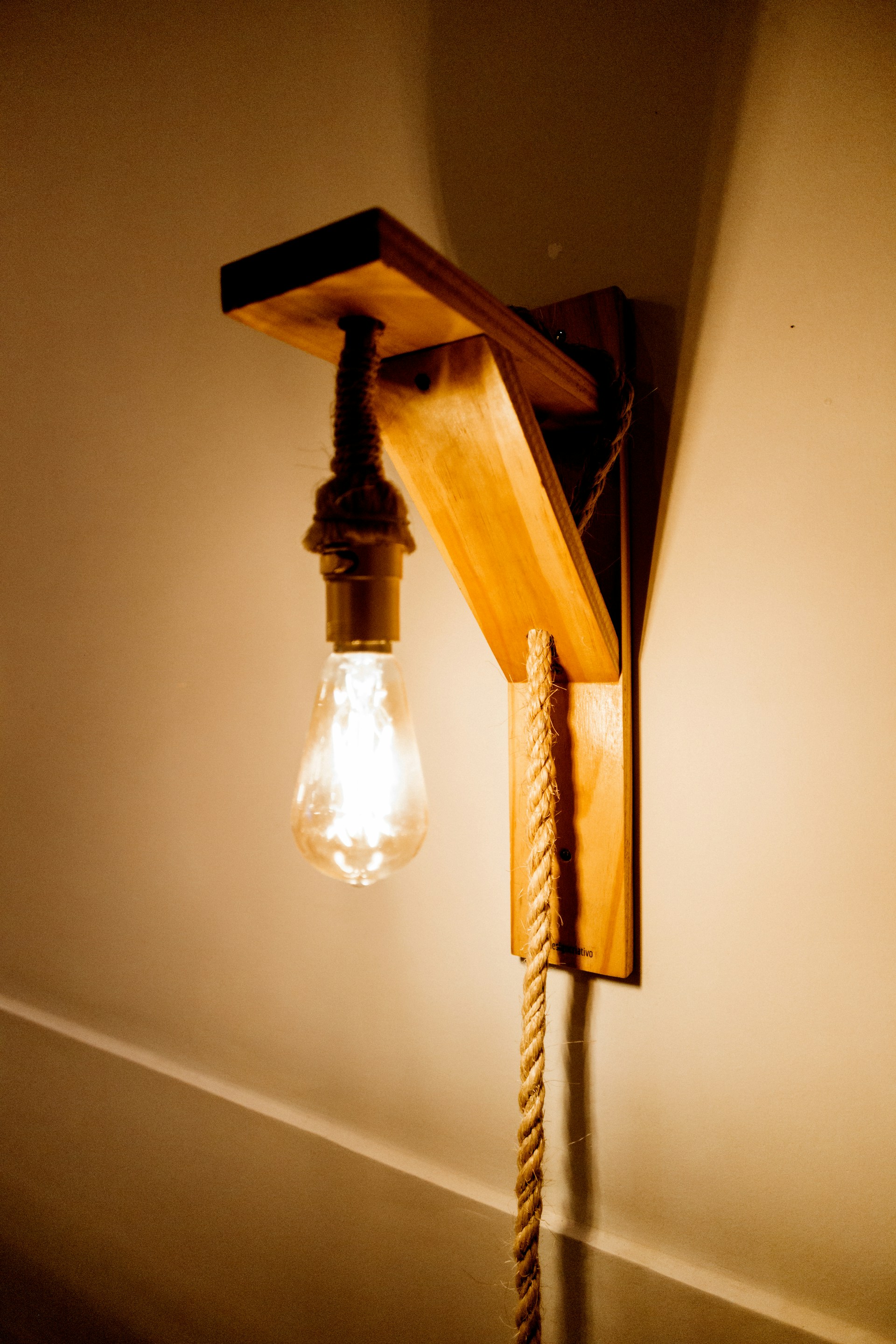 white pendant lamp turned on near white wall