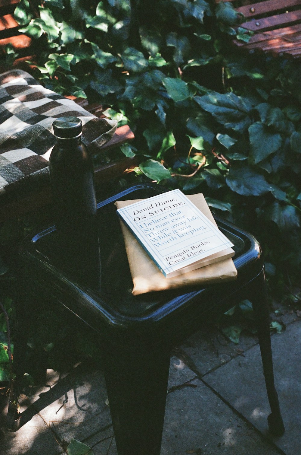 white book on black wooden table