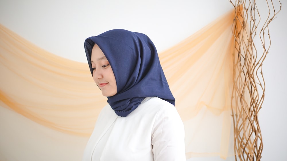 woman in white long sleeve shirt and blue hijab