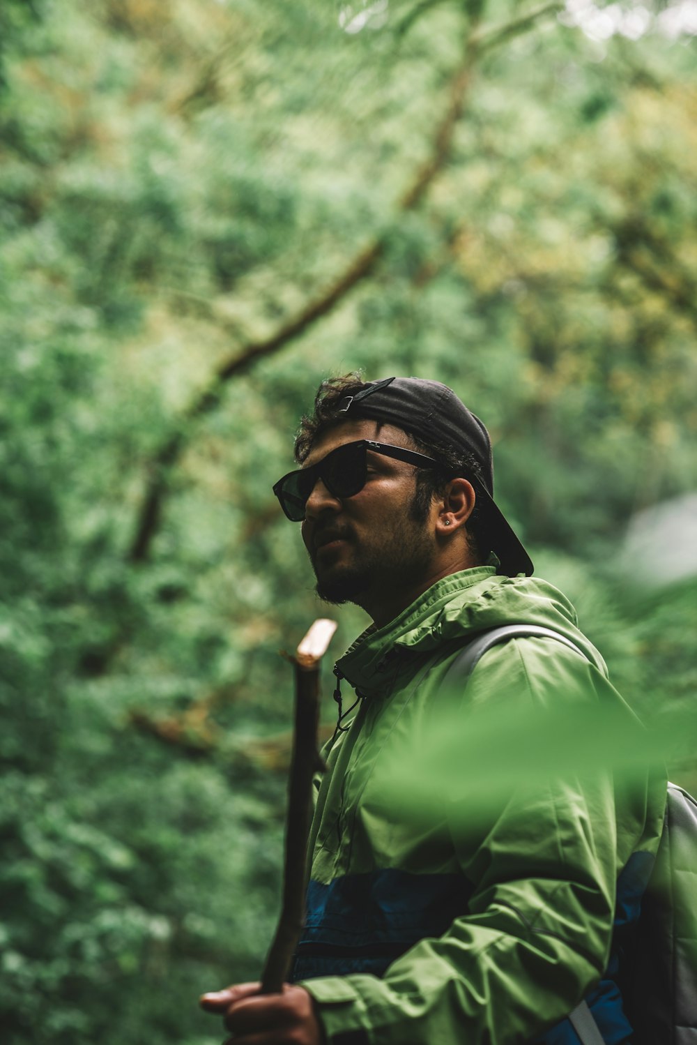 man in green jacket wearing black sunglasses