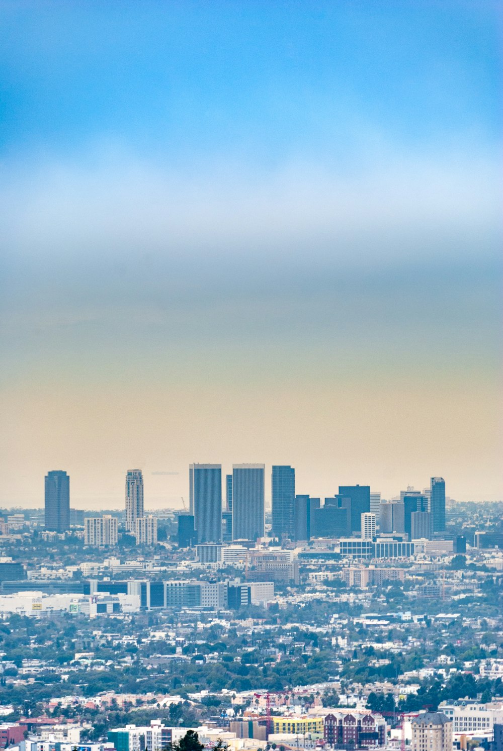 city skyline under white clouds during daytime