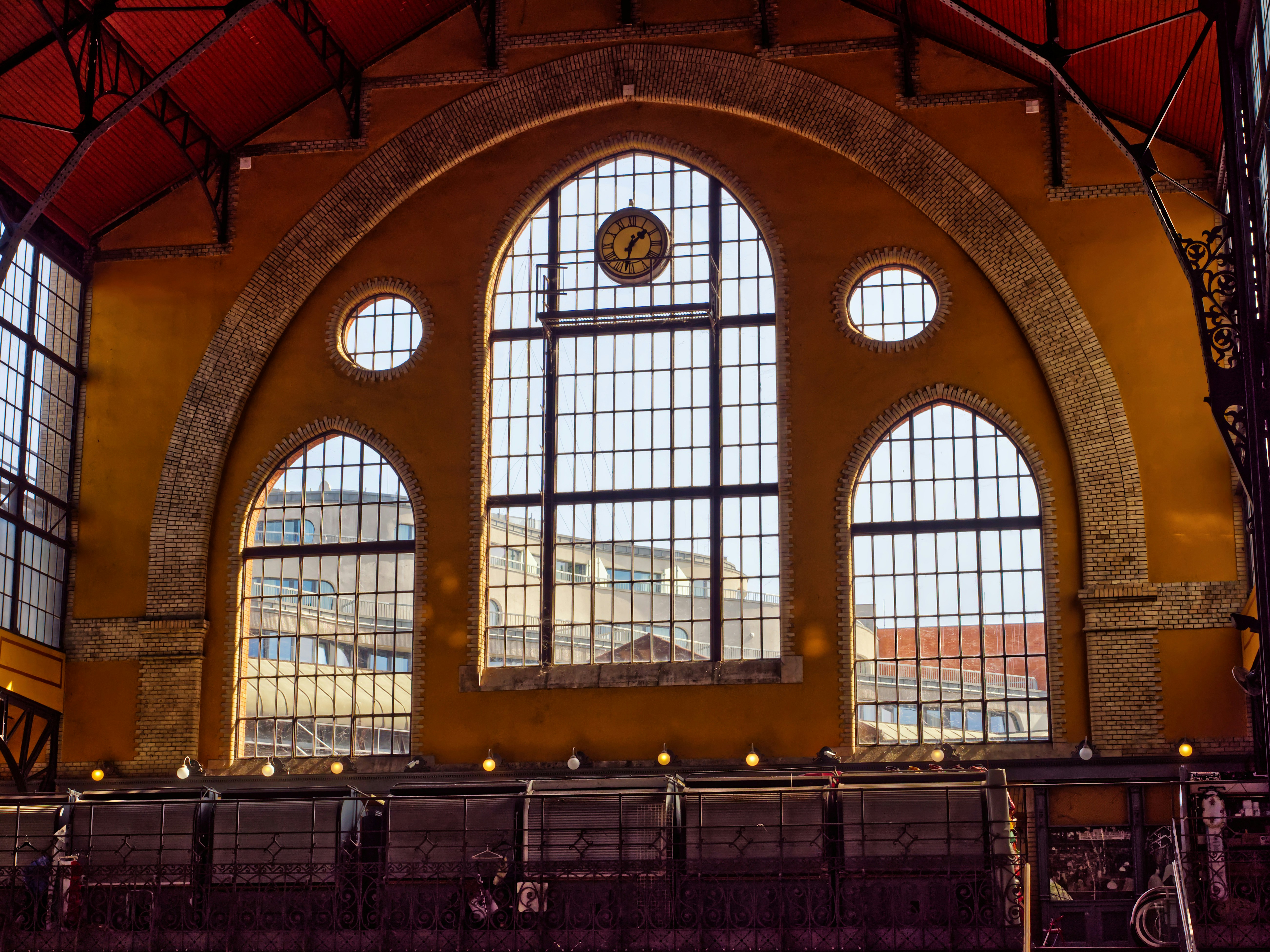 Industrial brick building with large arched windows being repurposed as an art space