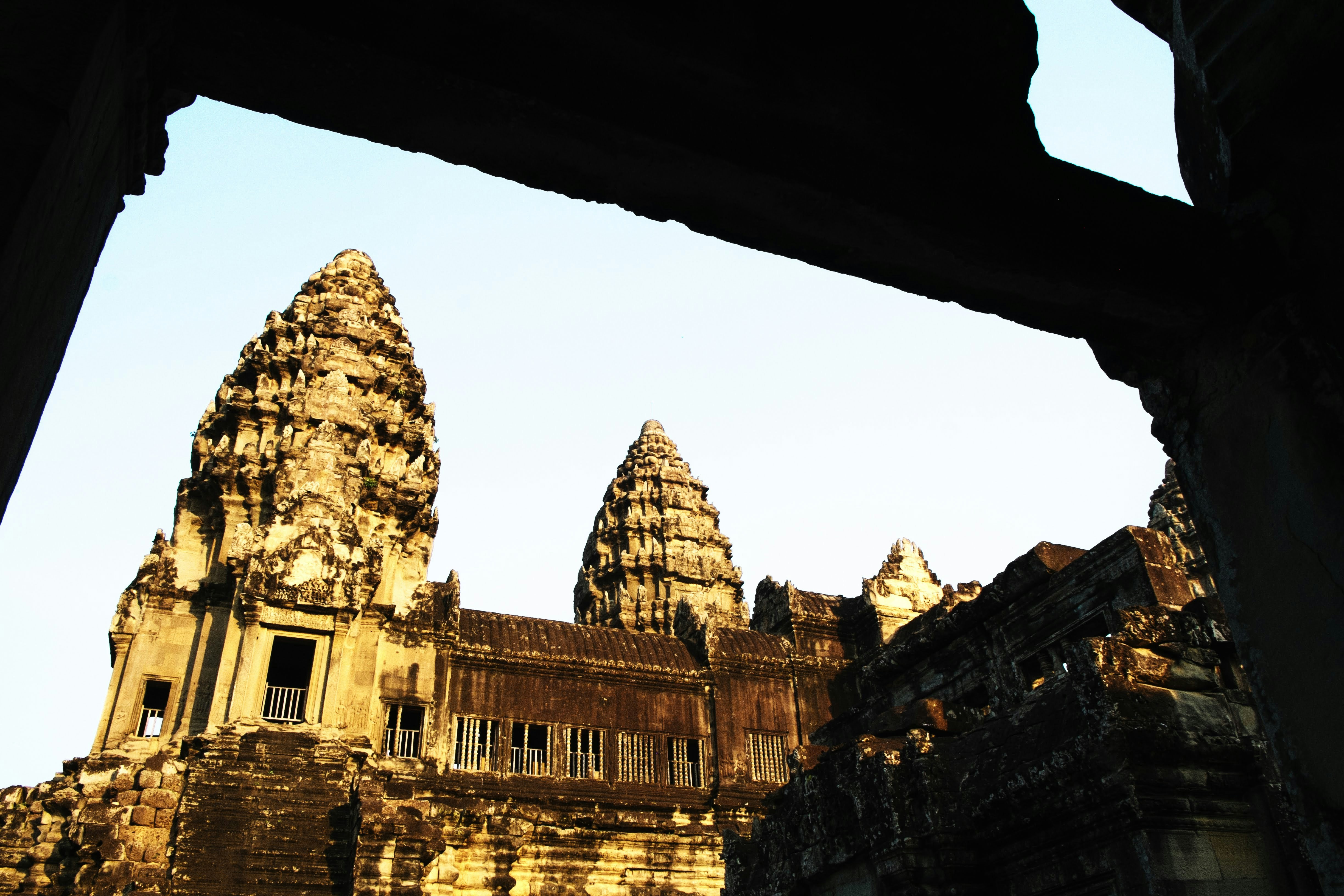 brown concrete building under white sky during daytime, Angkor Wat