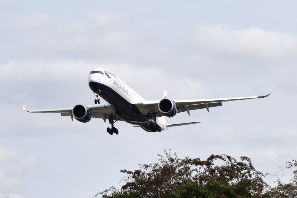 white and red passenger plane in the sky during daytime