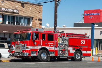 red and white fire truck parked near building during daytime