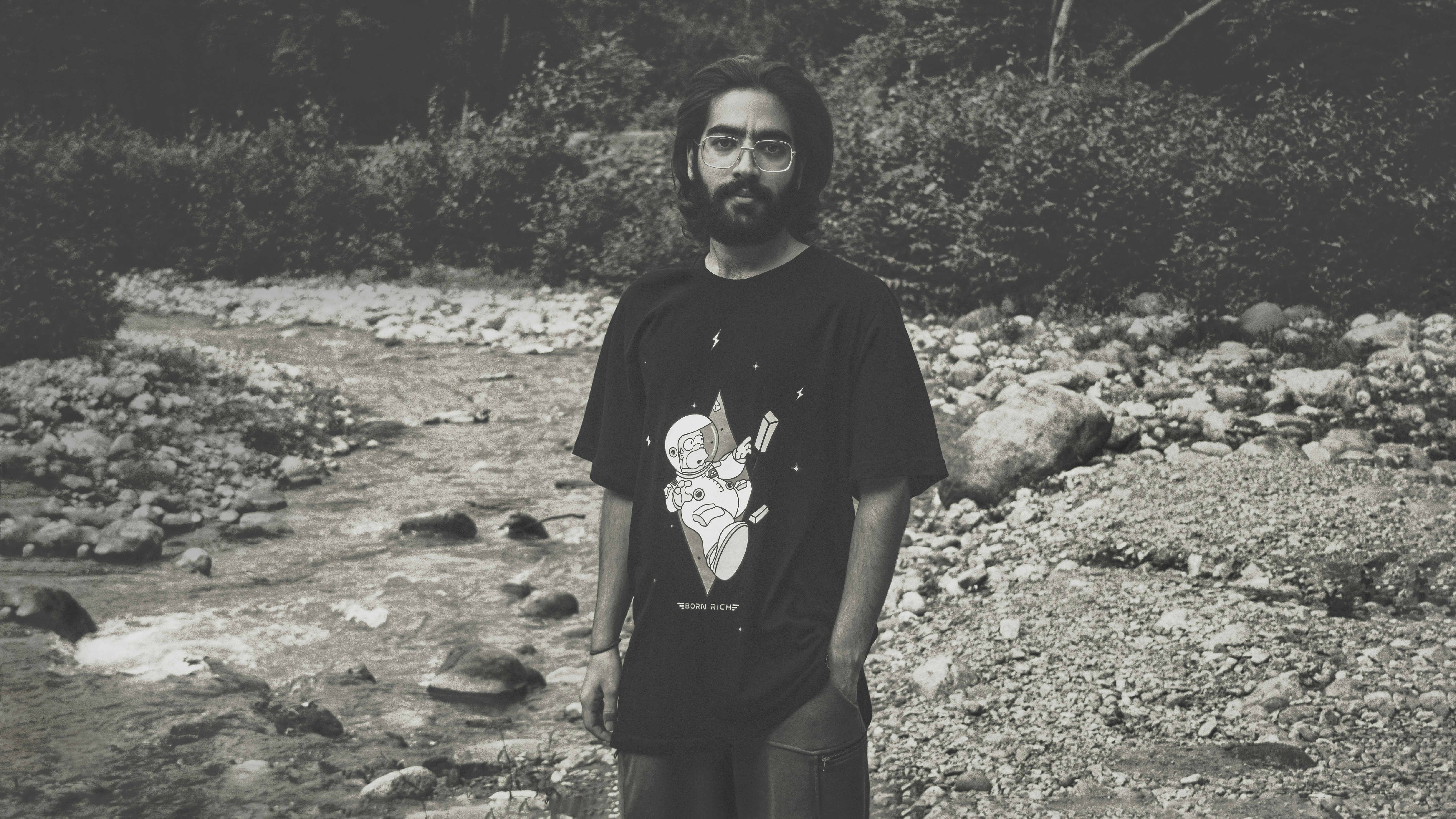 woman in black crew neck t-shirt standing on rocky ground during daytime