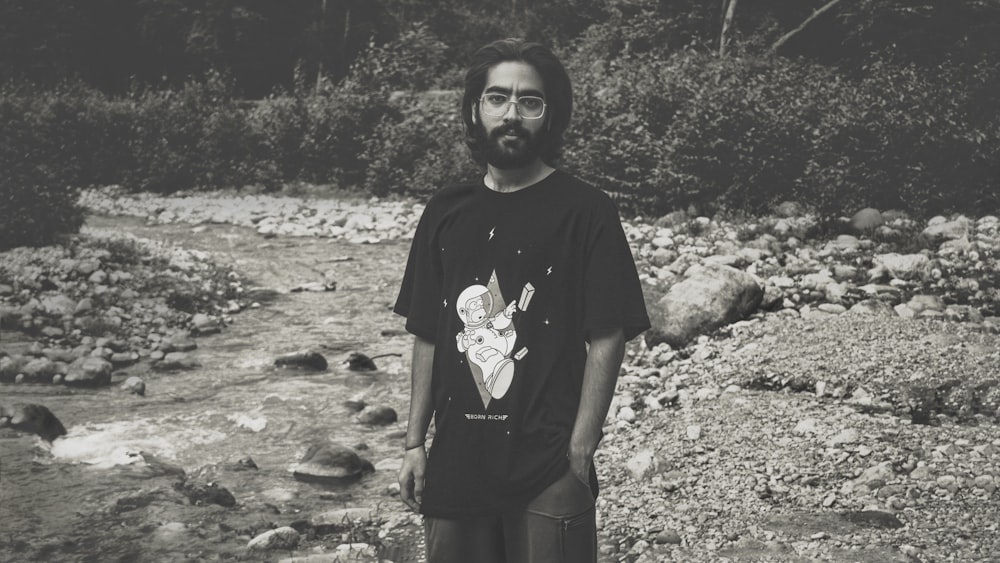 woman in black crew neck t-shirt standing on rocky ground during daytime