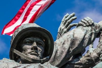 statue of man holding flag of america