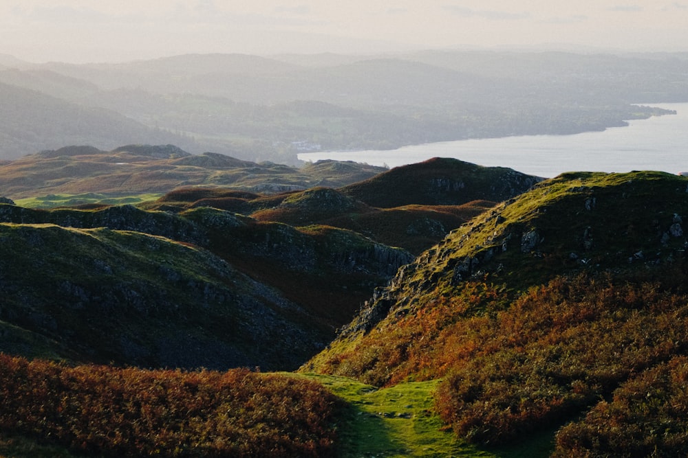 green and brown mountains under white sky during daytime