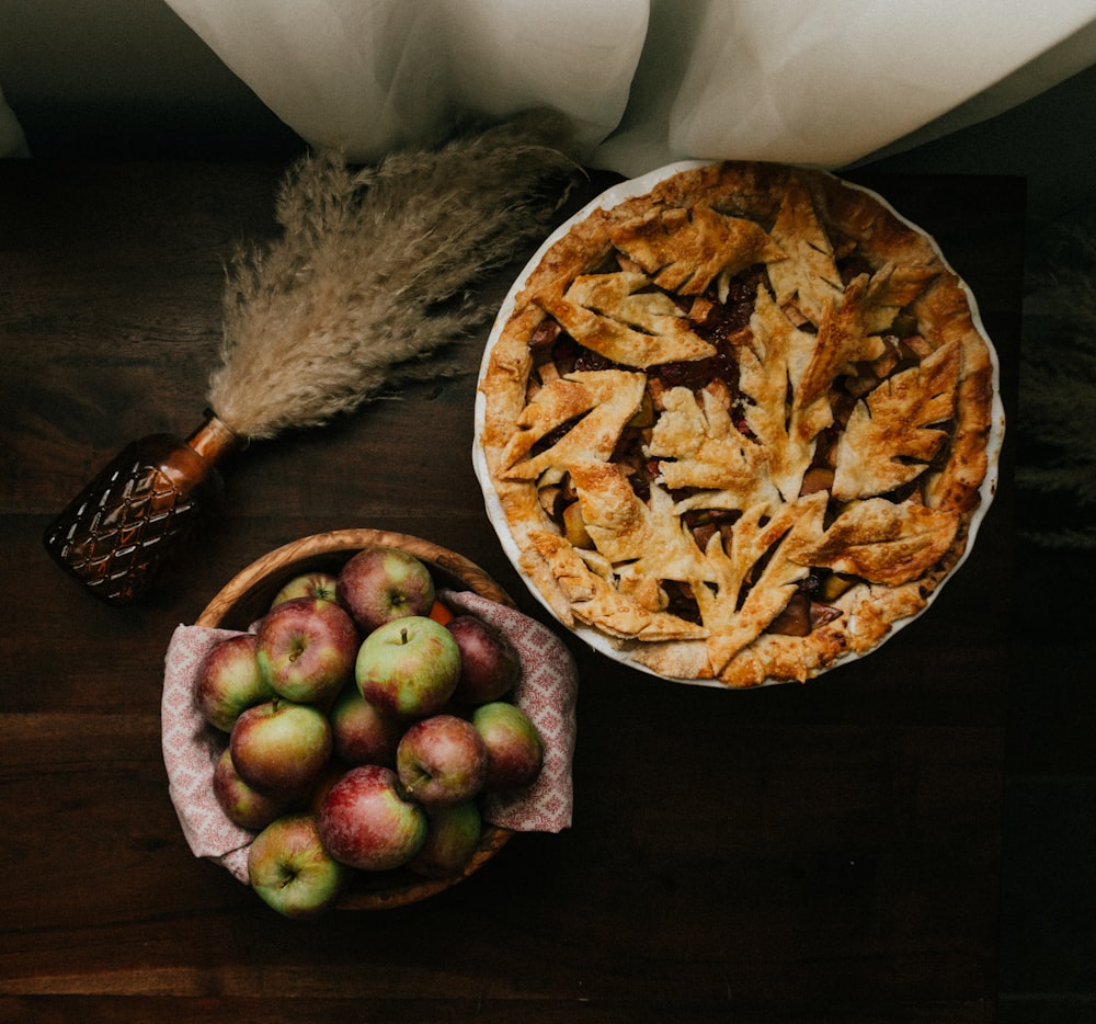 brown and green round fruit on brown wooden table