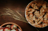 A warm, golden-brown homemade apple pie cooling on a rustic wooden table.