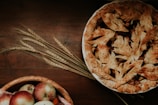 Freshly baked apple pies cooling on a rustic wooden counter, surrounded by farm garden produce.