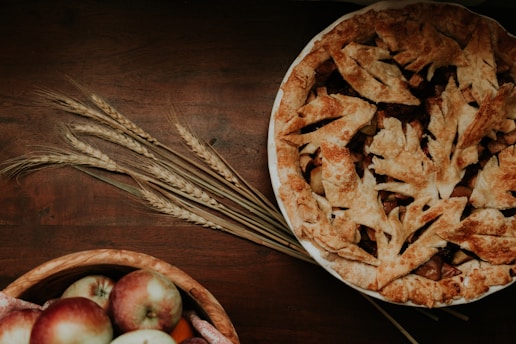 Warm-toned photo of a freshly baked apple pie with a golden crust on a beige linen cloth.