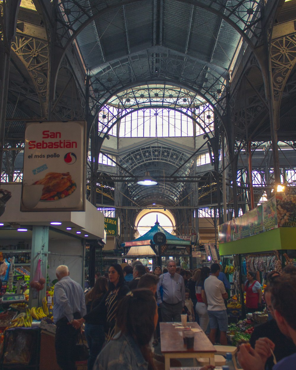 people in a building with glass roof