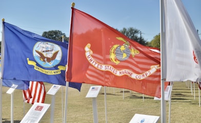 red and yellow flag on white pole during daytime