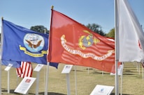 red and yellow flag on white pole during daytime