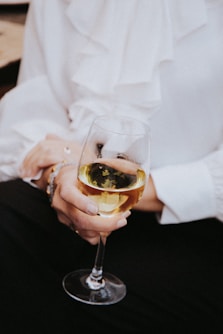 person holding clear wine glass