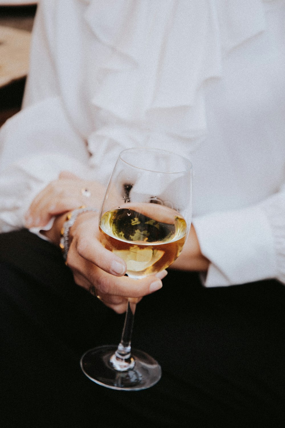 person holding clear wine glass