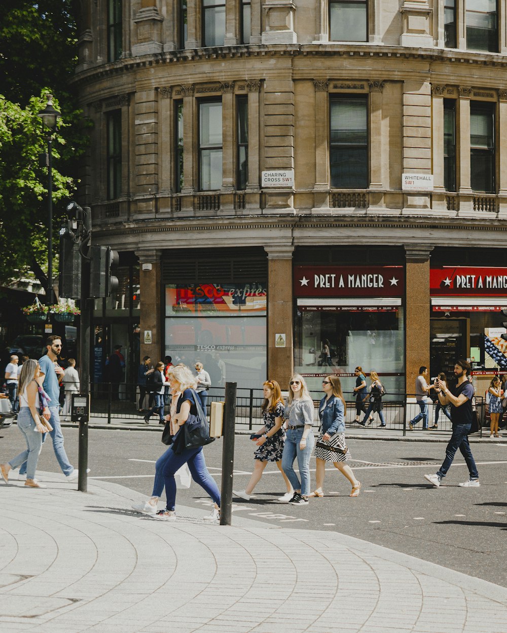 people walking on pedestrian lane near brown concrete building during daytime