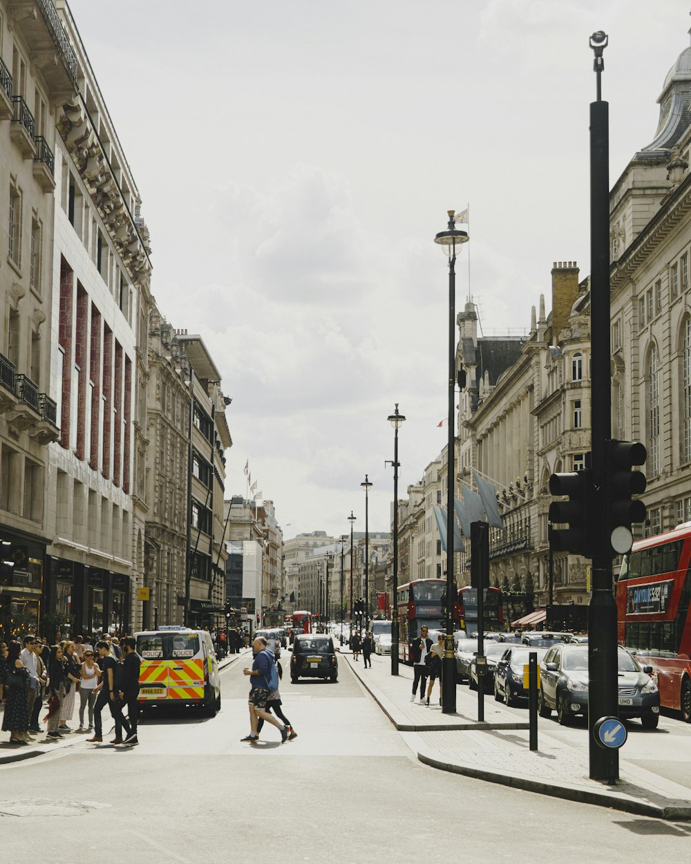 people walking on sidewalk near buildings during daytime