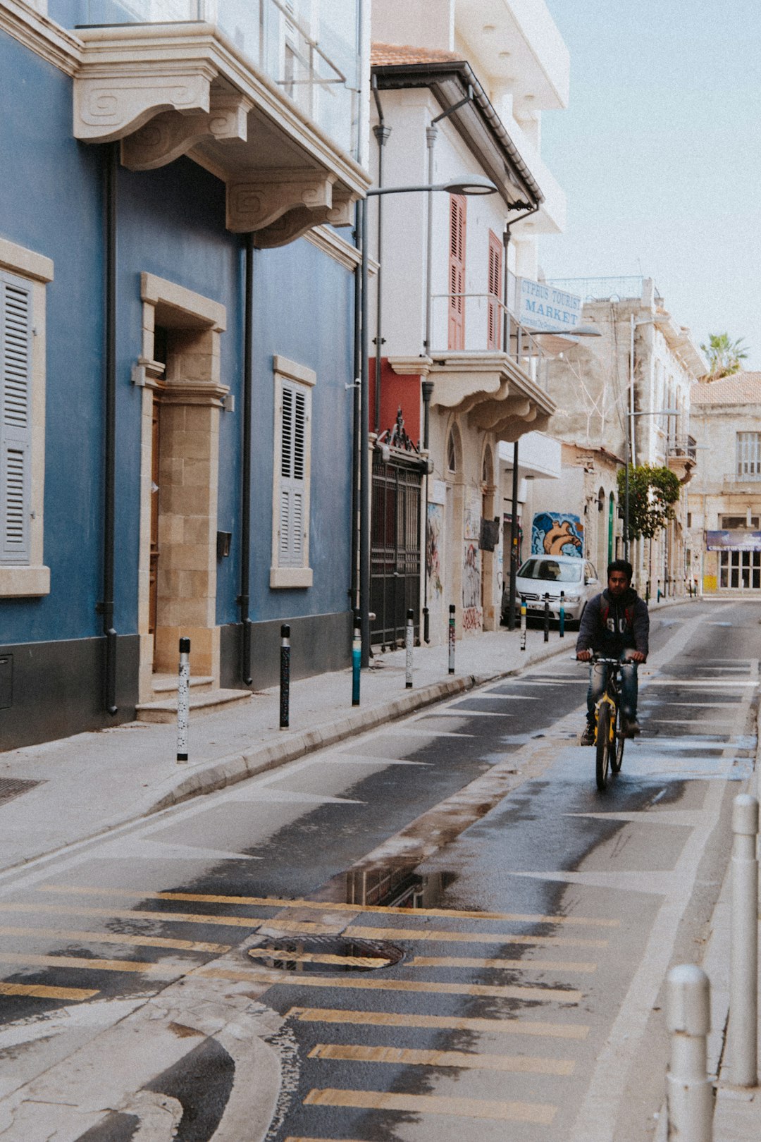 man in black jacket riding bicycle on road during daytime