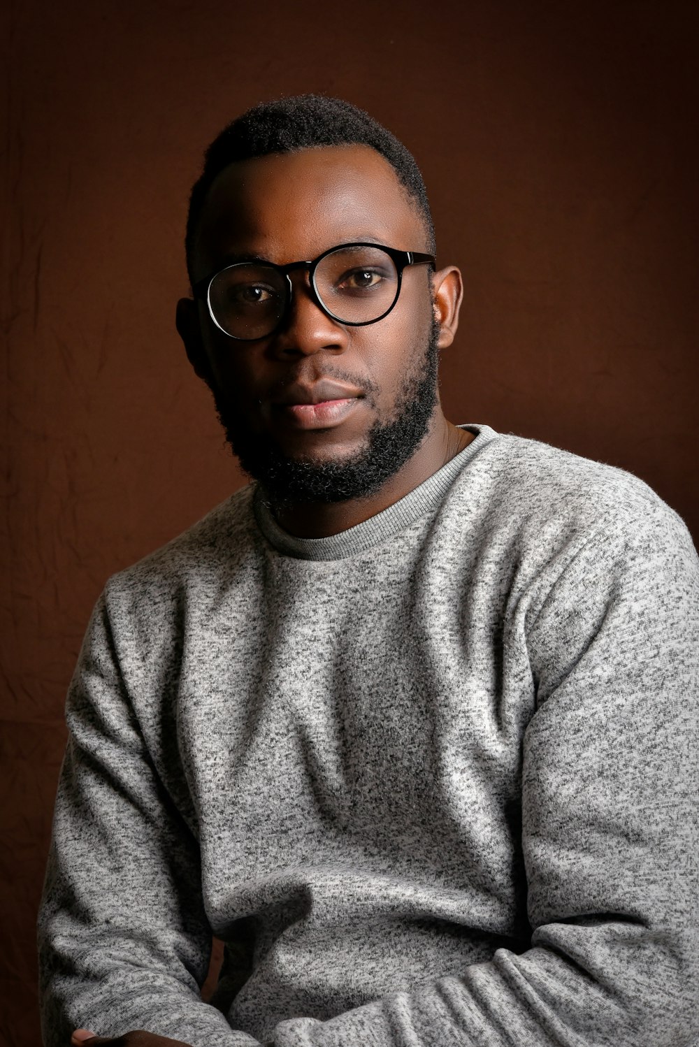 man in gray crew neck shirt wearing black framed eyeglasses