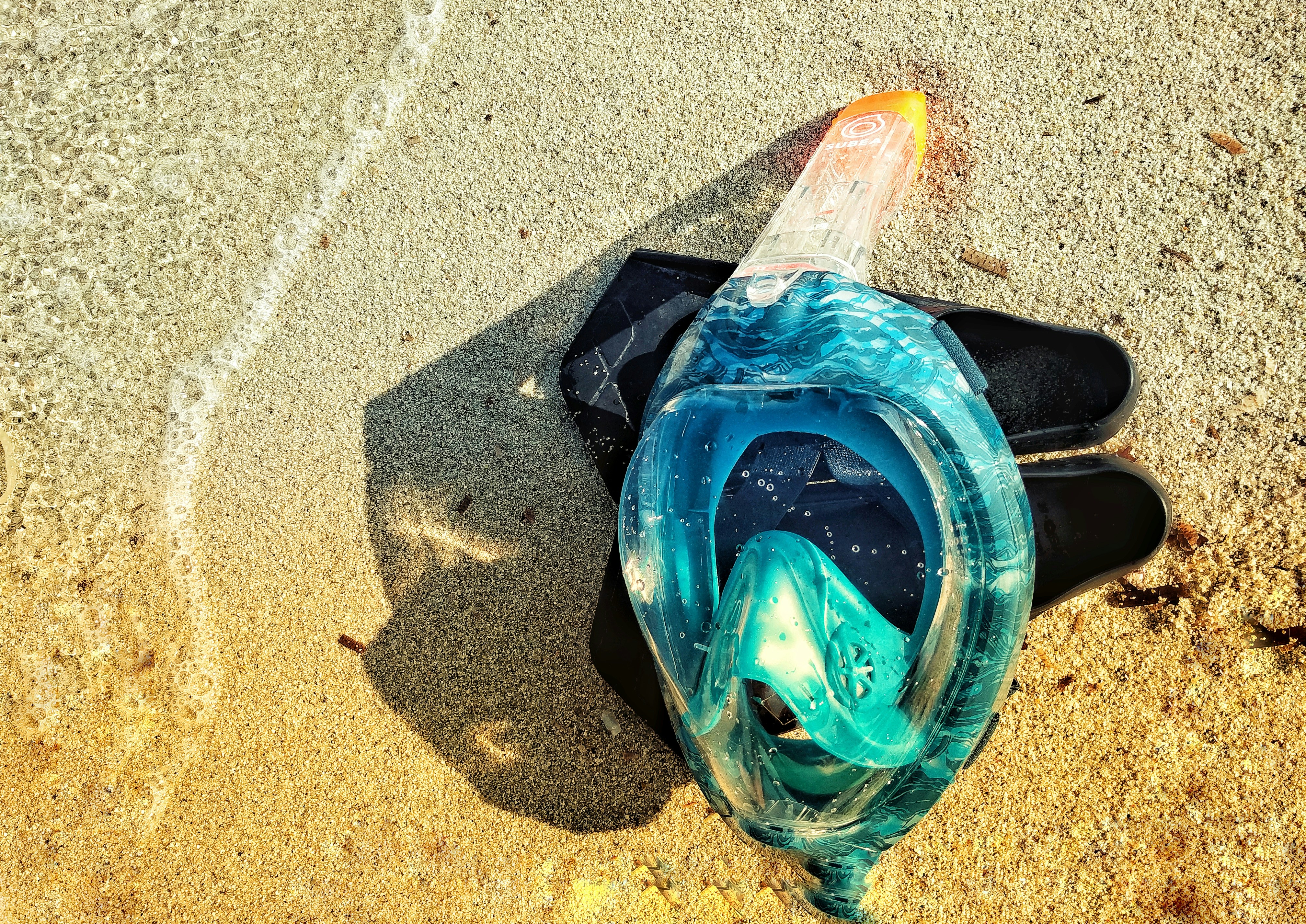 blue glass on gray sand