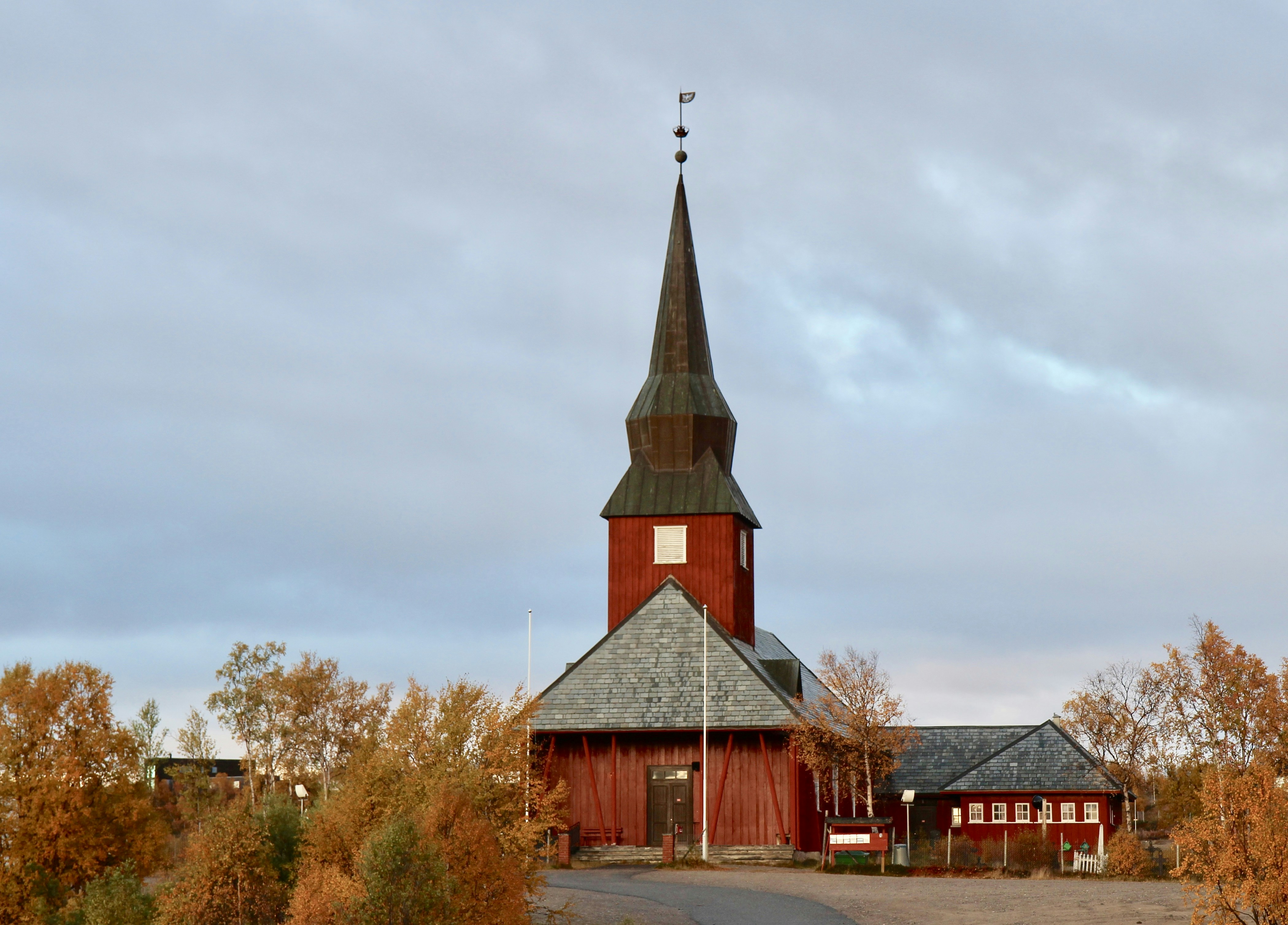 brown and white concrete church under cloudy sky during daytime