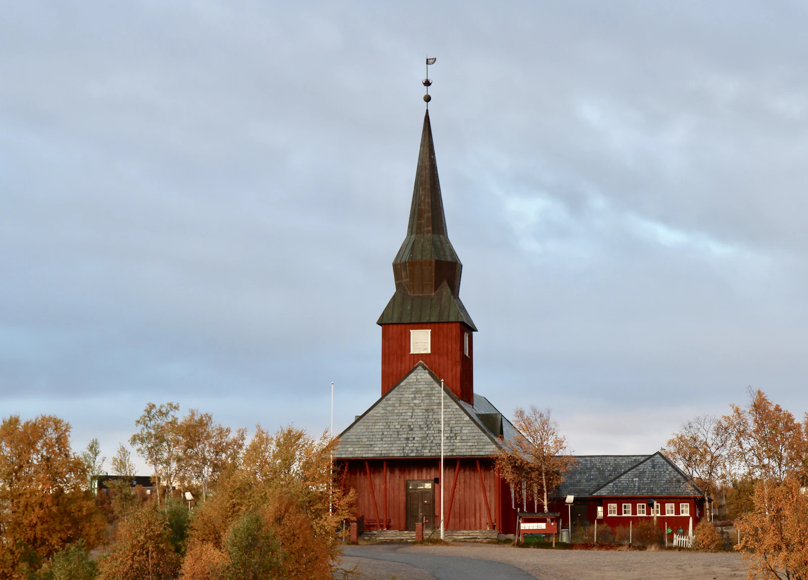 The red wooden church at Kautokeino on the Finnmark plateau, surrounded by autumn birch
