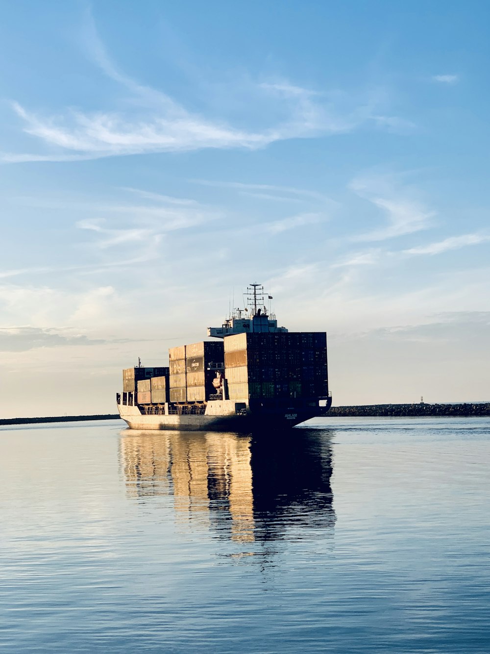 cargo ship on sea under blue sky during daytime