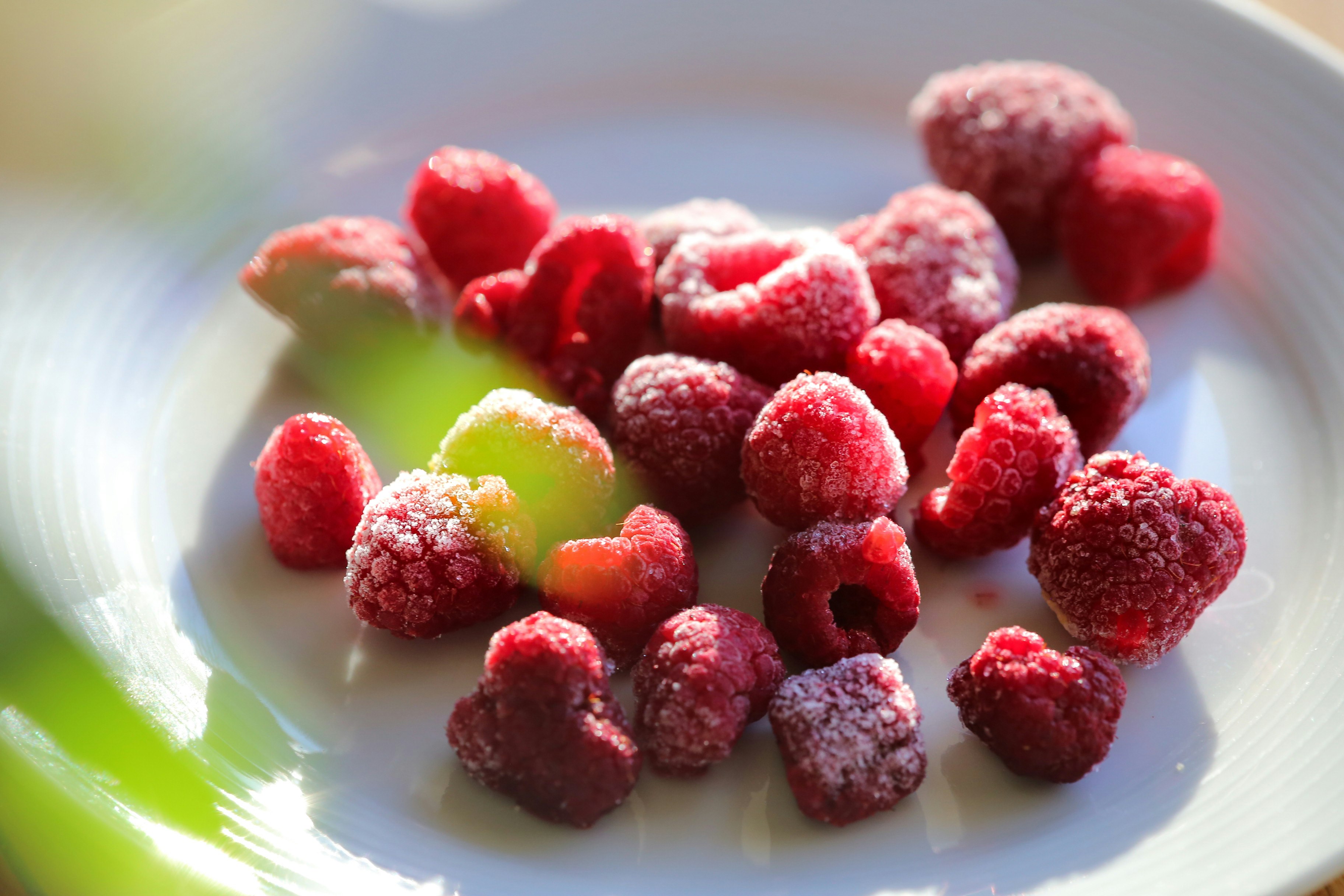 red and green fruit on white ceramic plate