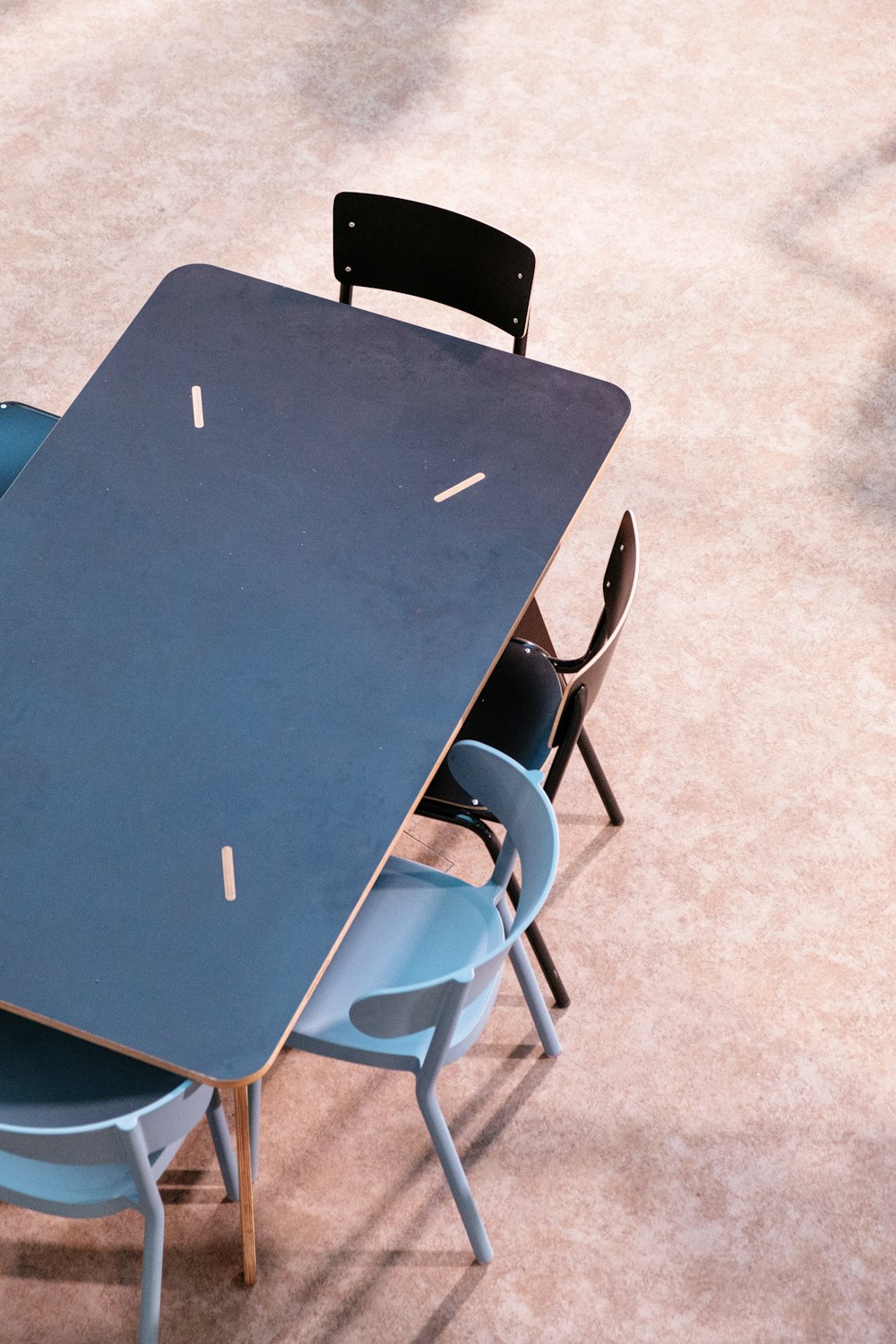 black laptop computer on blue table