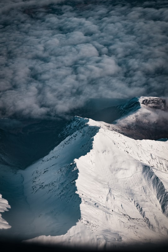 snow covered mountain under cloudy sky during daytime in Southern Alps New Zealand