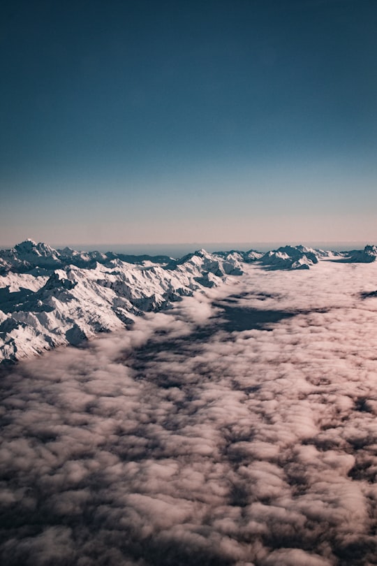 snow covered mountain under blue sky during daytime in Southern Alps New Zealand