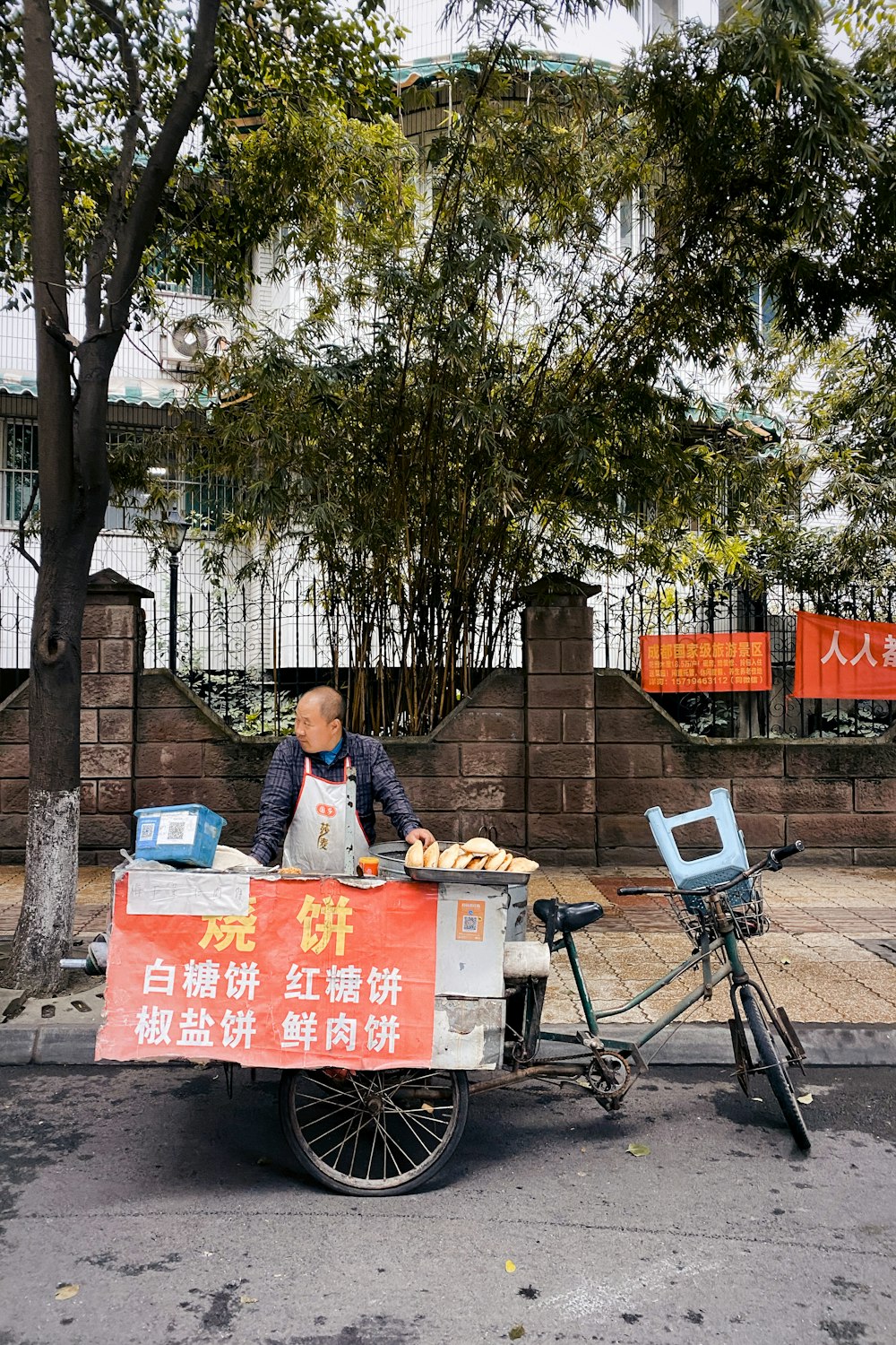 man in blue jacket sitting on black bicycle