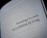 A close-up view of a book page with the text 'Technology is a tool, not a substitute for living.' printed in black letters.