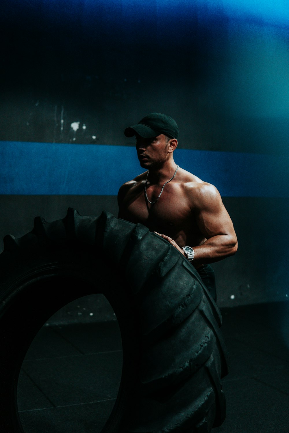 man in black cap and black shorts sitting on black round stairs