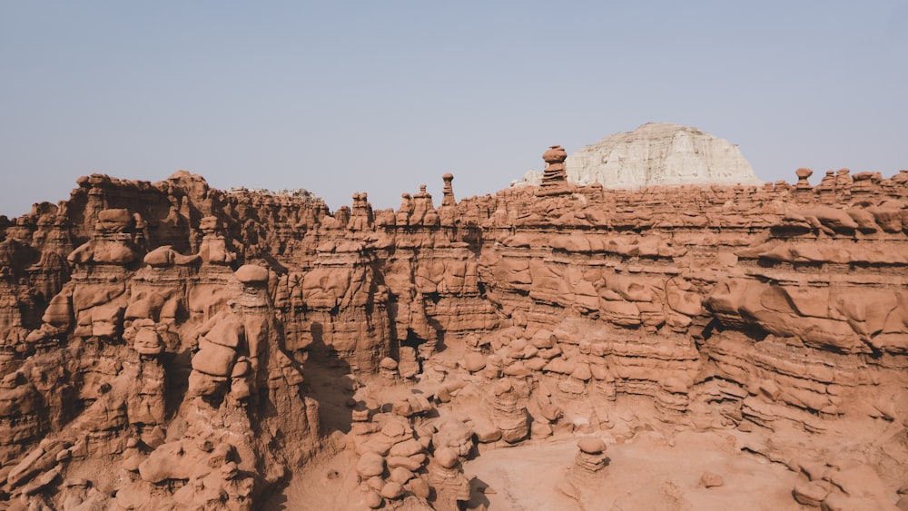 people standing on brown rock formation during daytime