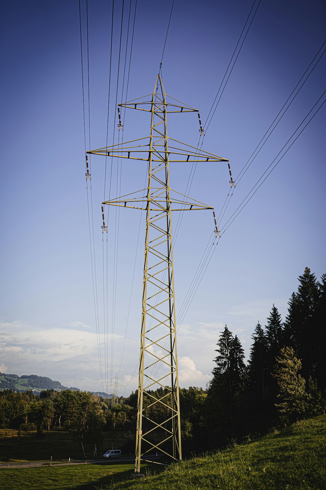 gray steel electric tower under blue sky during daytime