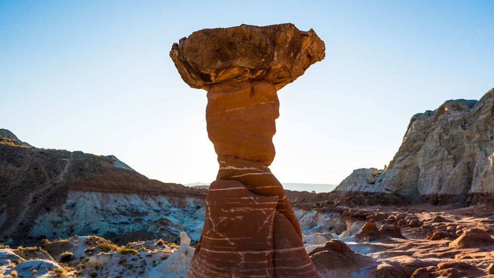 brown rock formation near body of water during daytime