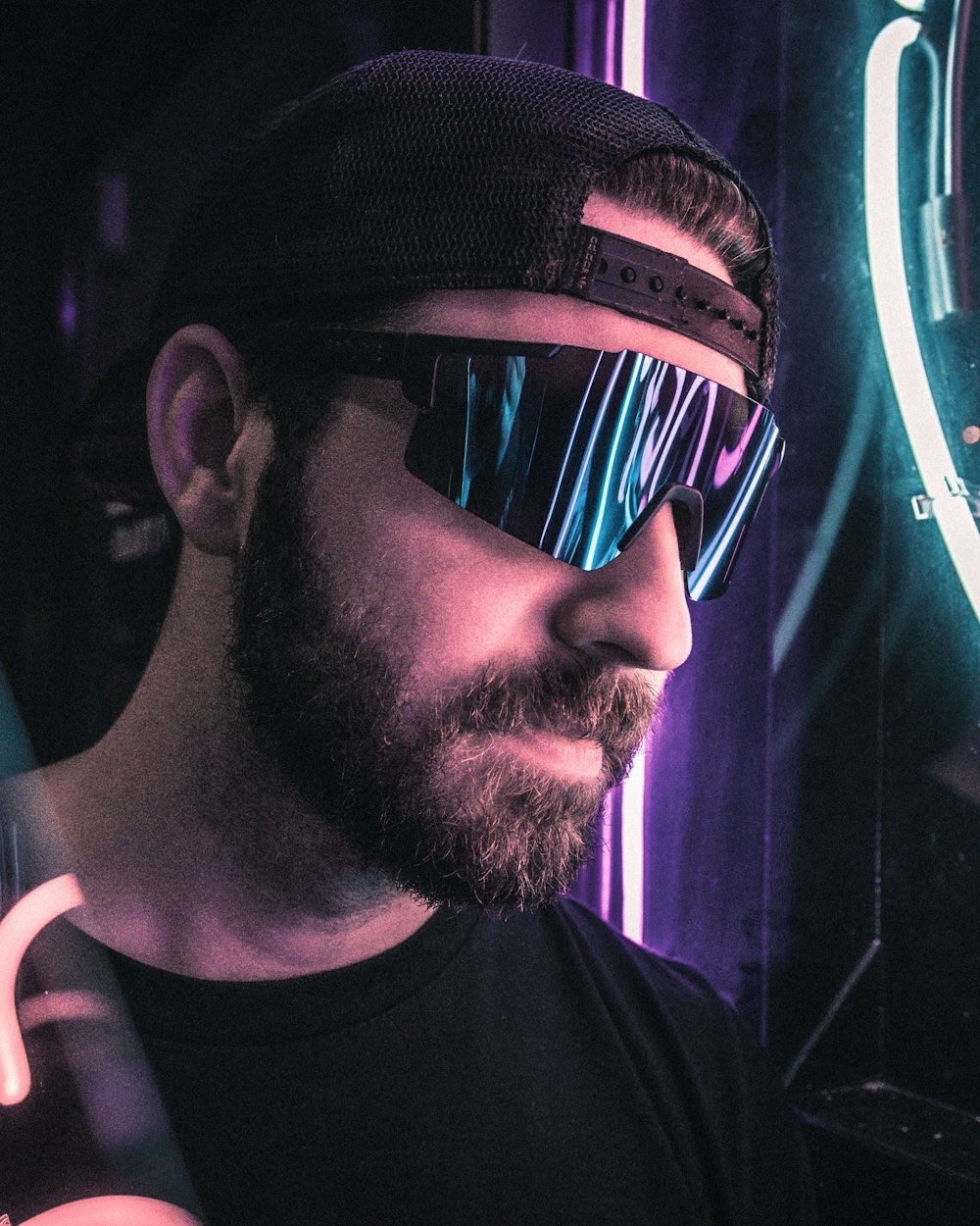 man in black tank top wearing black sunglasses and black fitted cap