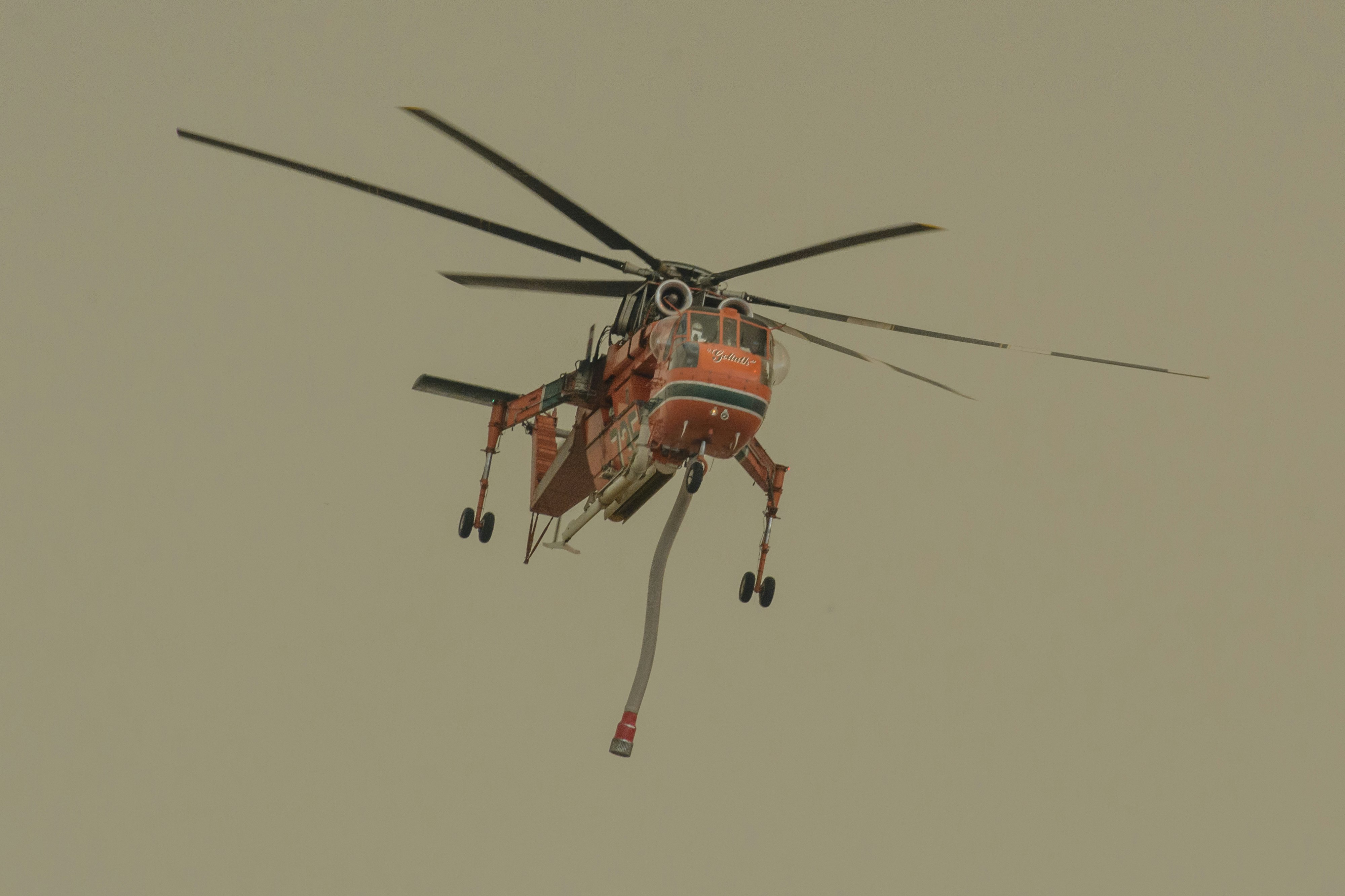 orange and black helicopter flying